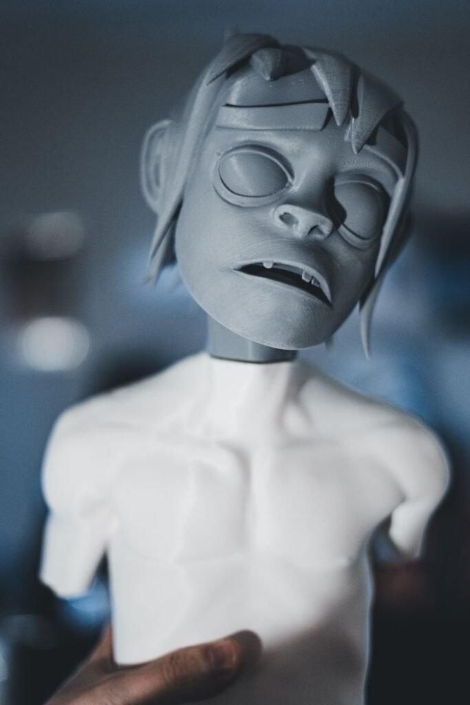 Close-up of a clay sculpture held by a hand, showcasing artistic details.